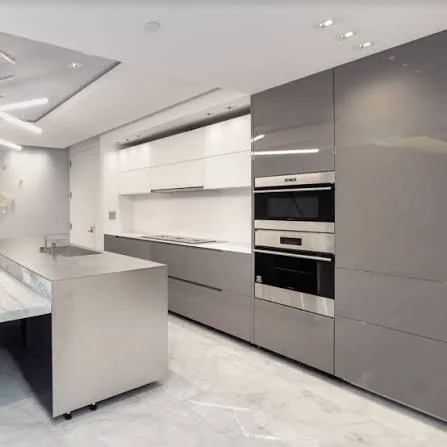 Contemporary kitchen with flat-panel gray cabinetry, tall built-in ovens, a stone-topped island and recessed ceiling lighting
