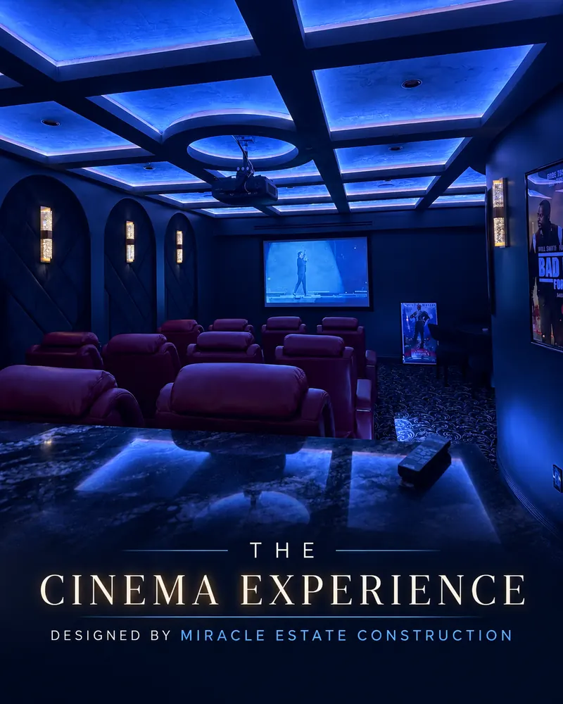 Home theater with burgundy recliners, a projection screen and a blue-lit coffered ceiling
